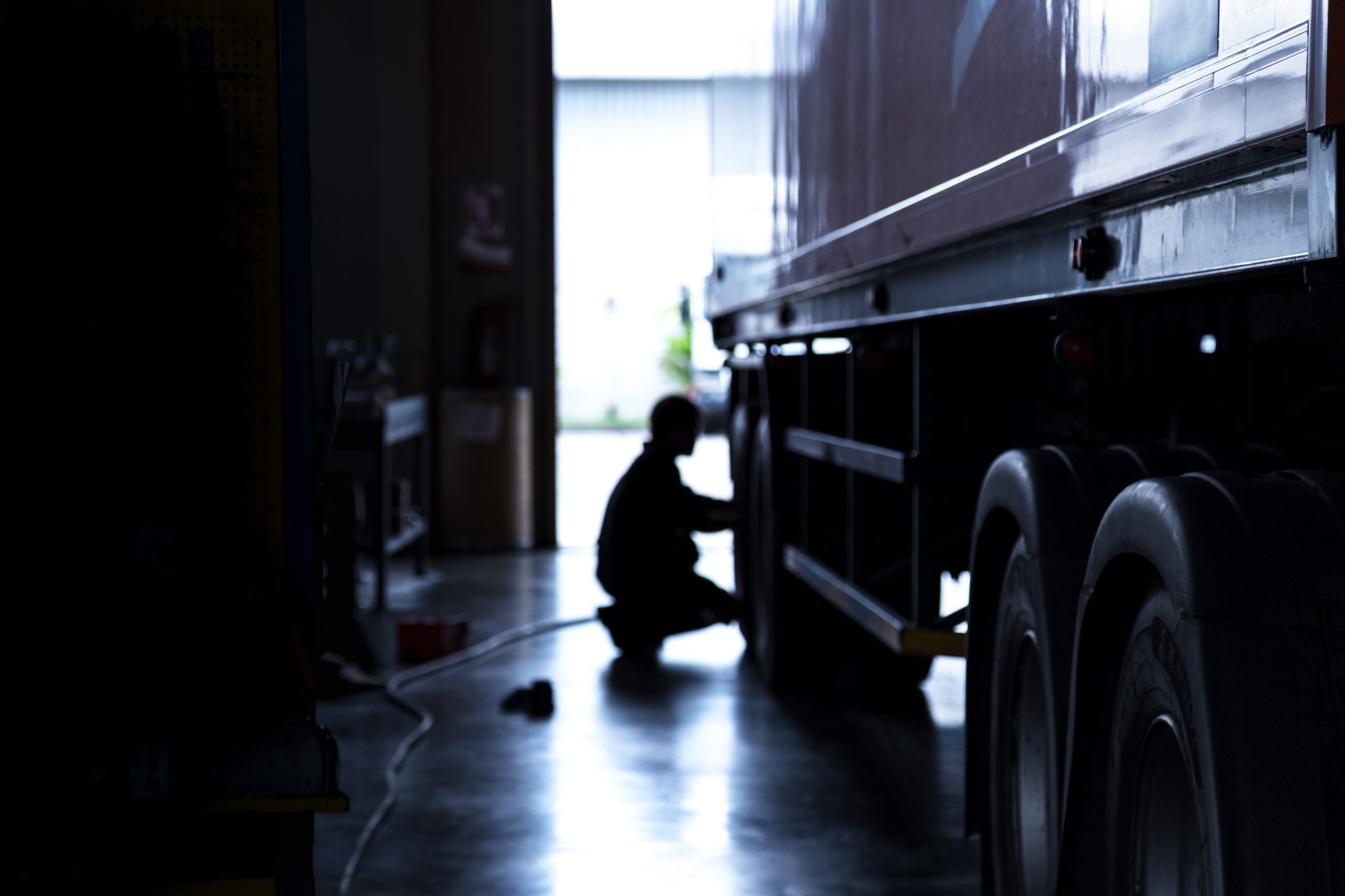 Mechanic working on a tire in a garage